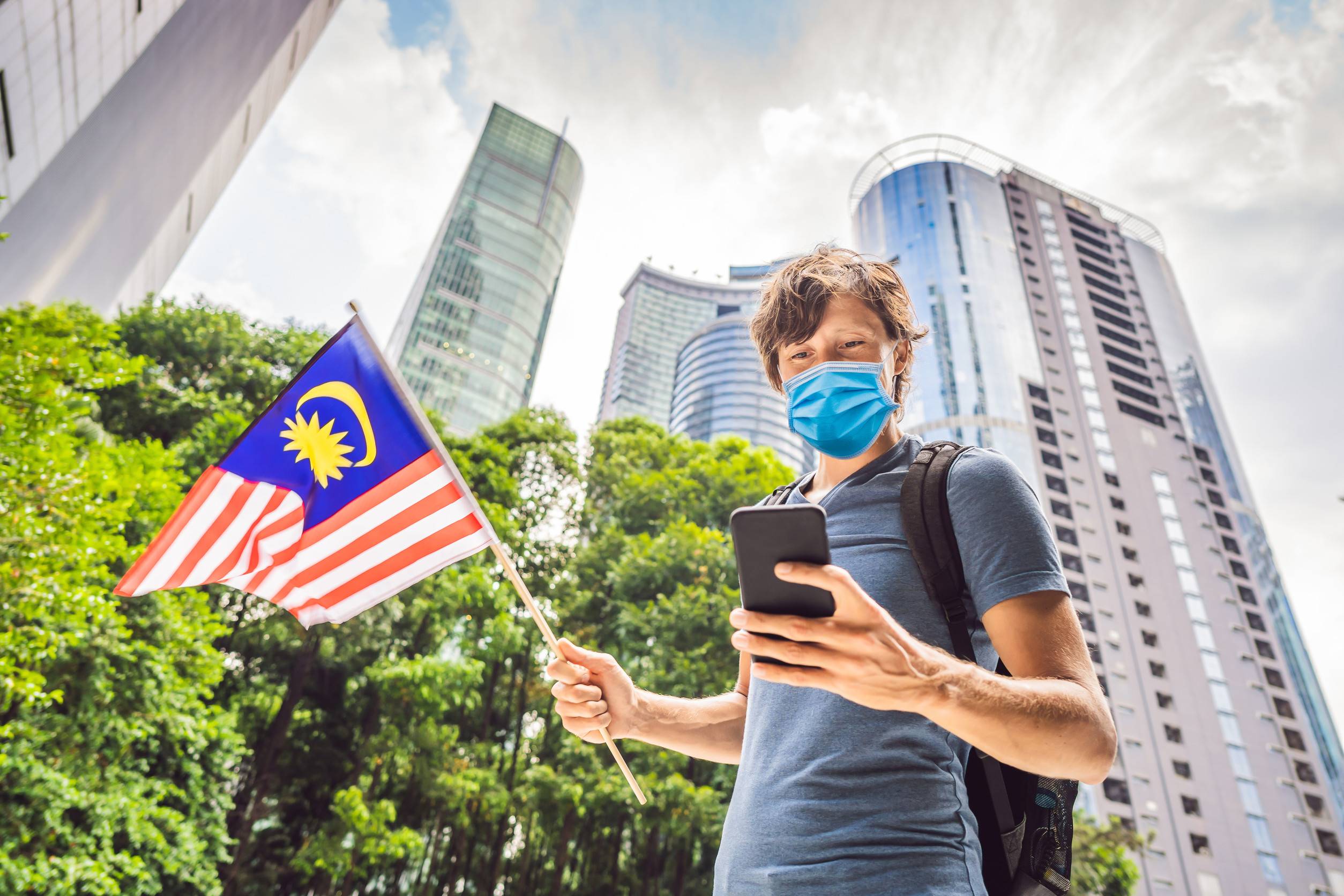 Mask Tourist With The Flag Of Malaysia Is Looking