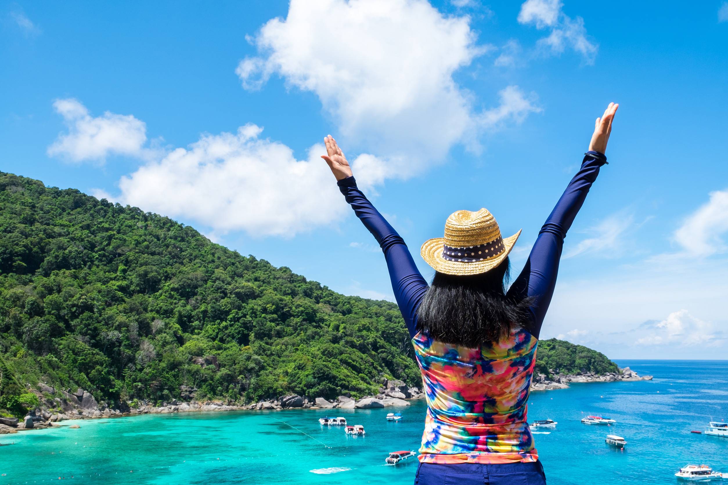 Traveller Woman With Colorful Swimming Suit Raised Arms To Sky At Top Of Mountain